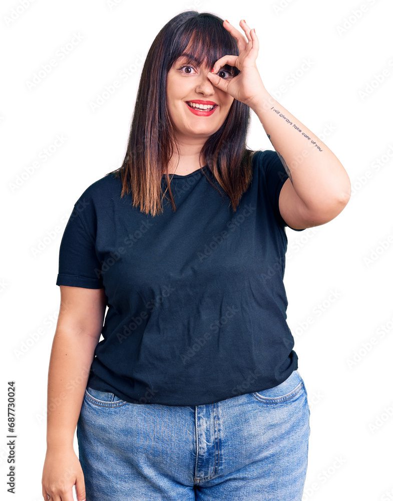 Young plus size woman wearing casual clothes doing ok gesture with hand smiling, eye looking through fingers with happy face. Young plus size woman wearing casual clothes doing ok gesture with hand smiling, eye looking through fingers with happy face.