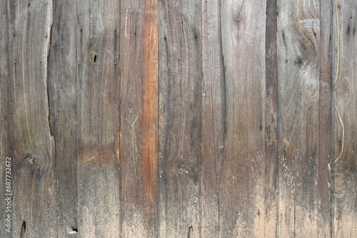 The background is an old wooden floor with patterns from age and decay.