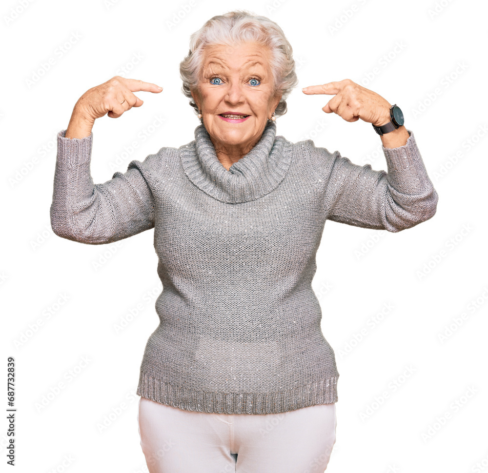 Senior grey-haired woman wearing casual winter sweater smiling pointing to head with both hands finger, great idea or thought, good memory Senior grey-haired woman wearing casual winter sweater smiling pointing to head with both hands finger, great idea or thought, good memory