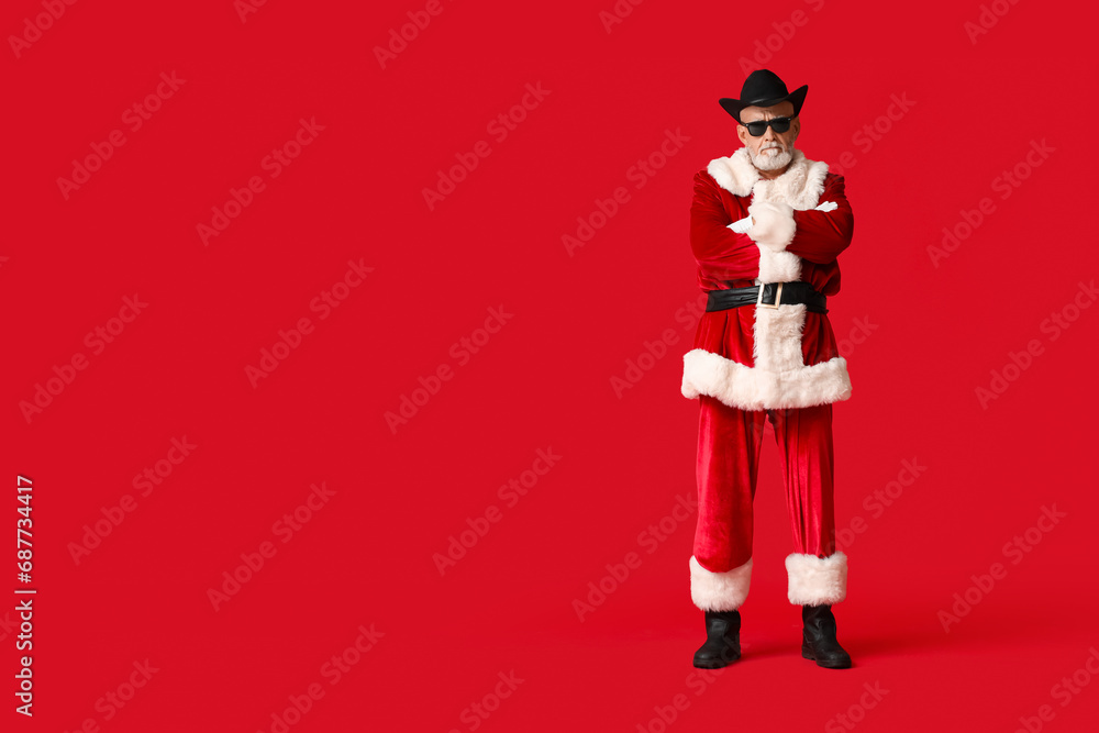 Santa Claus in stylish hat on red background Santa Claus in stylish hat on red background