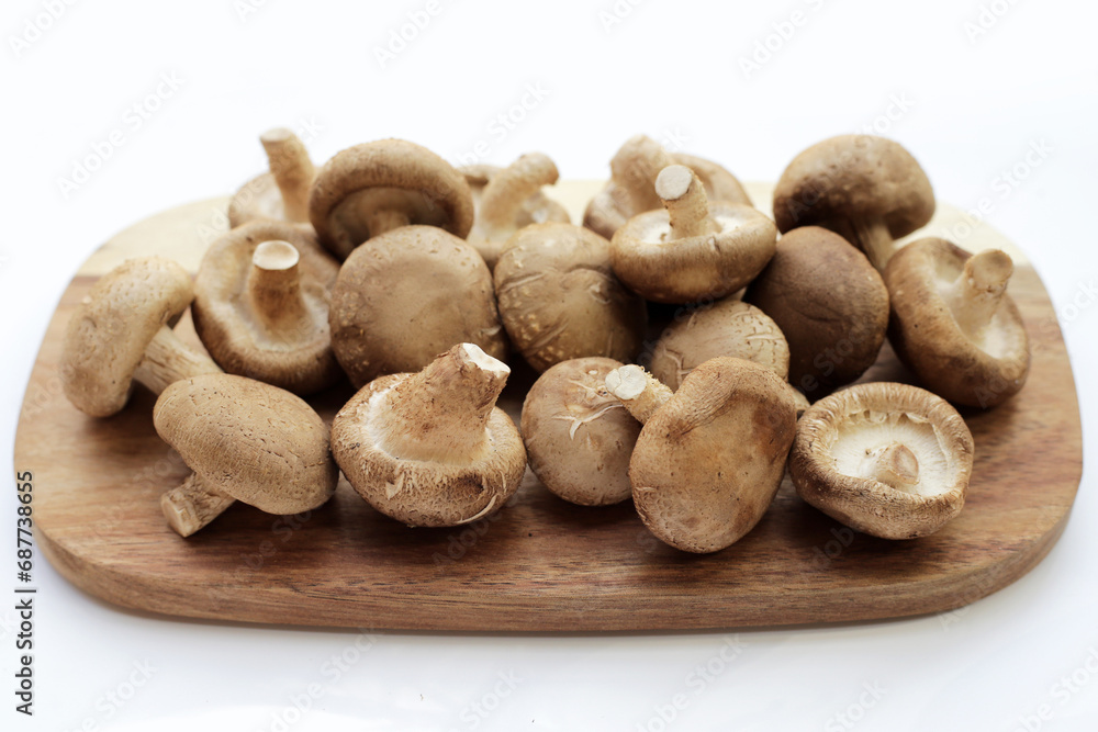 Fresh shiitake mushrooms on white background.