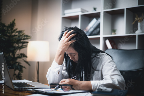 A woman battles depression and stress in her workplace, highlighting the challenges faced by professionals. This image captures the impact of mental health on employees in a corporate environment.