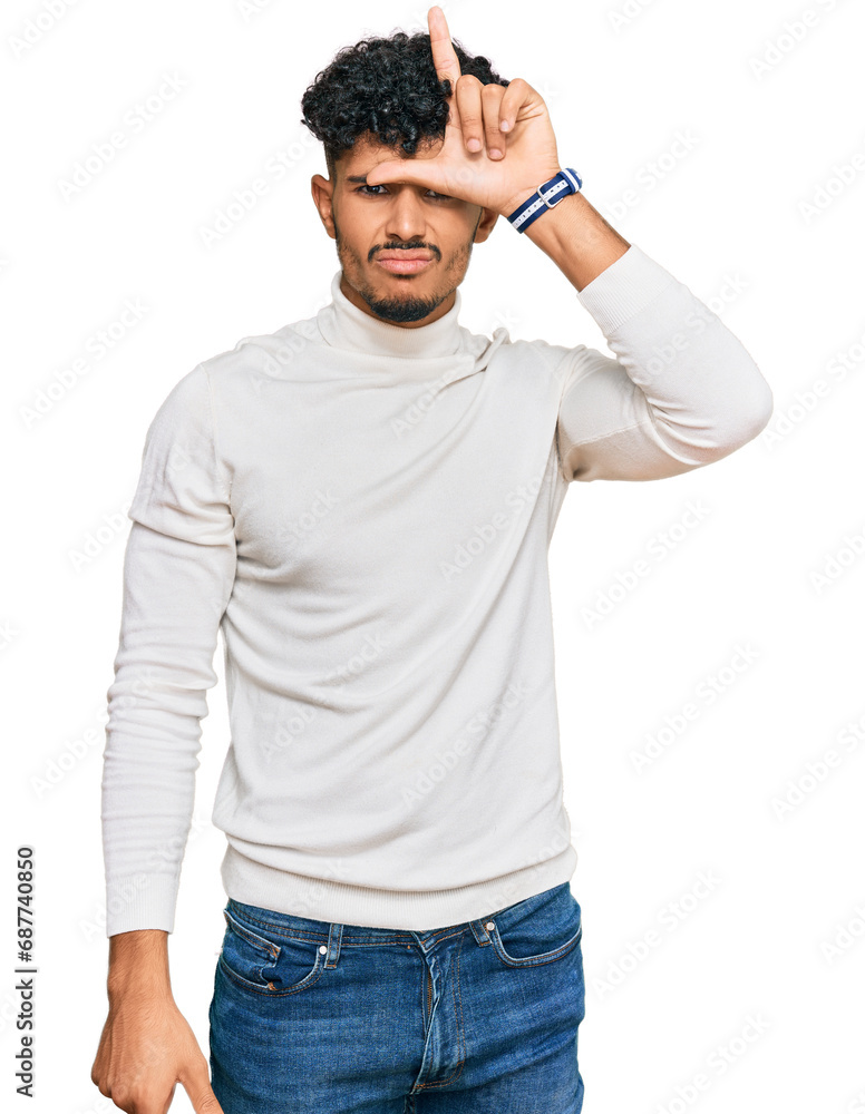 Young arab man wearing casual winter sweater making fun of people with fingers on forehead doing loser gesture mocking and insulting. Young arab man wearing casual winter sweater making fun of people with fingers on forehead doing loser gesture mocking and insulting.