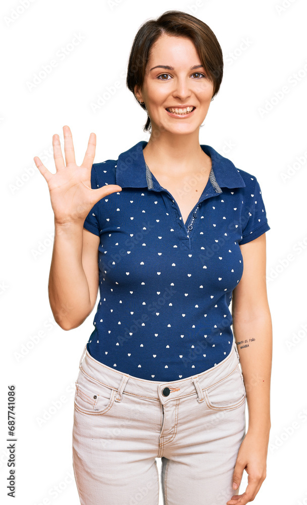 Young brunette woman with short hair wearing casual clothes showing and pointing up with fingers number five while smiling confident and happy. Young brunette woman with short hair wearing casual clothes showing and pointing up with fingers number five while smiling confident and happy.