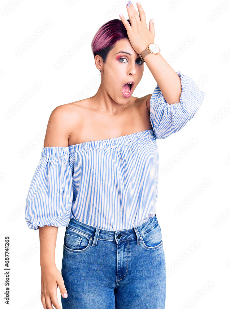 Fototapeta premium Young beautiful woman with pink hair wearing casual clothes surprised with hand on head for mistake, remember error. forgot, bad memory concept.