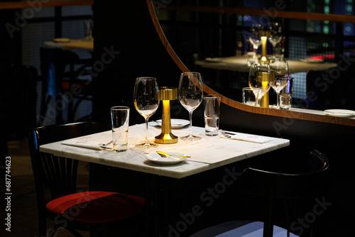 фотографія A cozy and elegant table setting for a romantic dinner in a dimly lit restaurant