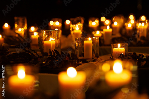 Candles on the table glowing in the night.