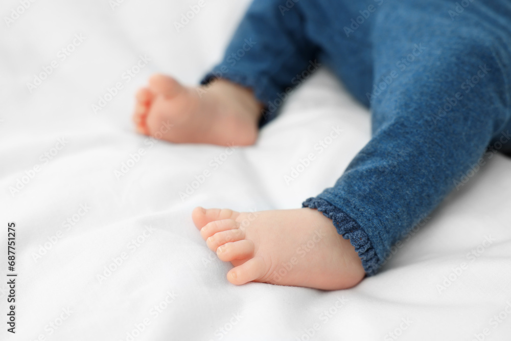 Newborn baby lying on white blanket, closeup Newborn baby lying on white blanket, closeup