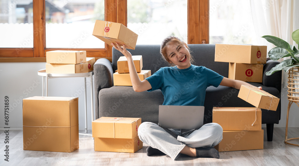 Happy small business owner working online, prepare to pack the boxes for customers, SME business ideas online. Happy small business owner working online, prepare to pack the boxes for customers, SME business ideas online.
