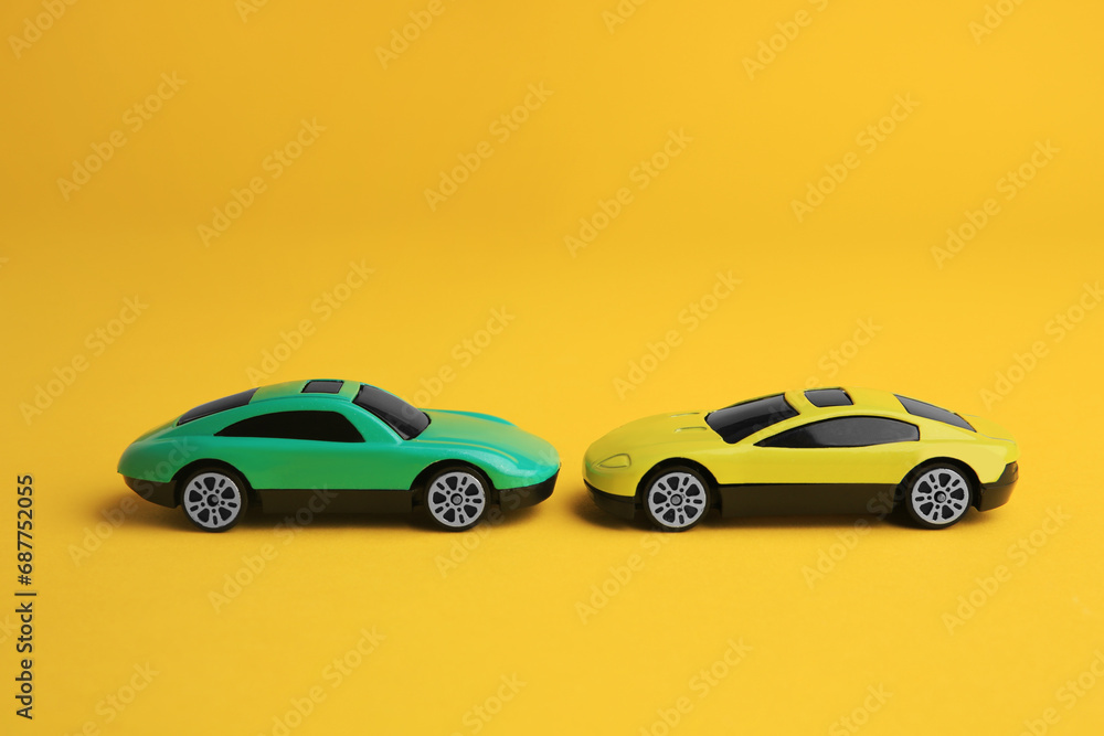 Bright cars on yellow background. Children`s toys