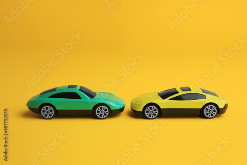 Bright cars on yellow background. Children`s toys © New Africa