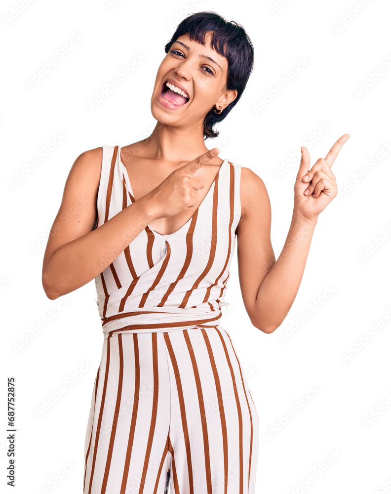 Young brunette woman with short hair wearing summer outfit smiling and looking at the camera pointing with two hands and fingers to the side. Young brunette woman with short hair wearing summer outfit smiling and looking at the camera pointing with two hands and fingers to the side.