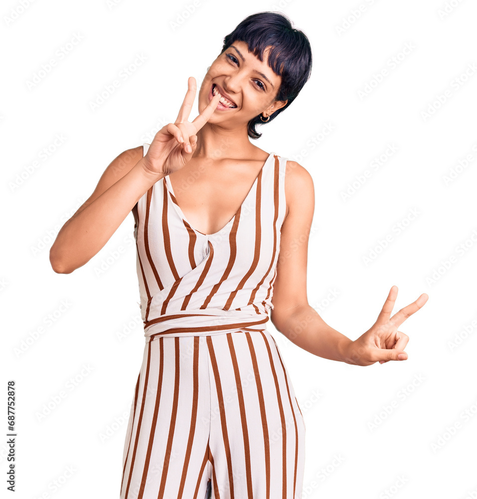 Young brunette woman with short hair wearing summer outfit smiling looking to the camera showing fingers doing victory sign. number two. Young brunette woman with short hair wearing summer outfit smiling looking to the camera showing fingers doing victory sign. number two.
