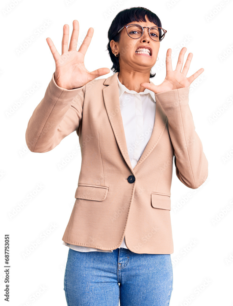 Young brunette woman with short hair wearing business jacket and glasses afraid and terrified with fear expression stop gesture with hands, shouting in shock. panic concept. Young brunette woman with short hair wearing business jacket and glasses afraid and terrified with fear expression stop gesture with hands, shouting in shock. panic concept.