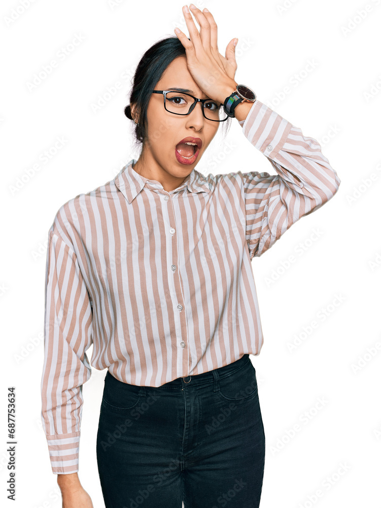 Young hispanic girl wearing casual clothes and glasses surprised with hand on head for mistake, remember error. forgot, bad memory concept. Young hispanic girl wearing casual clothes and glasses surprised with hand on head for mistake, remember error. forgot, bad memory concept.
