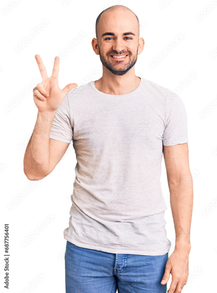 Young handsome man wearing casual t shirt showing and pointing up with fingers number three while smiling confident and happy. Young handsome man wearing casual t shirt showing and pointing up with fingers number three while smiling confident and happy.
