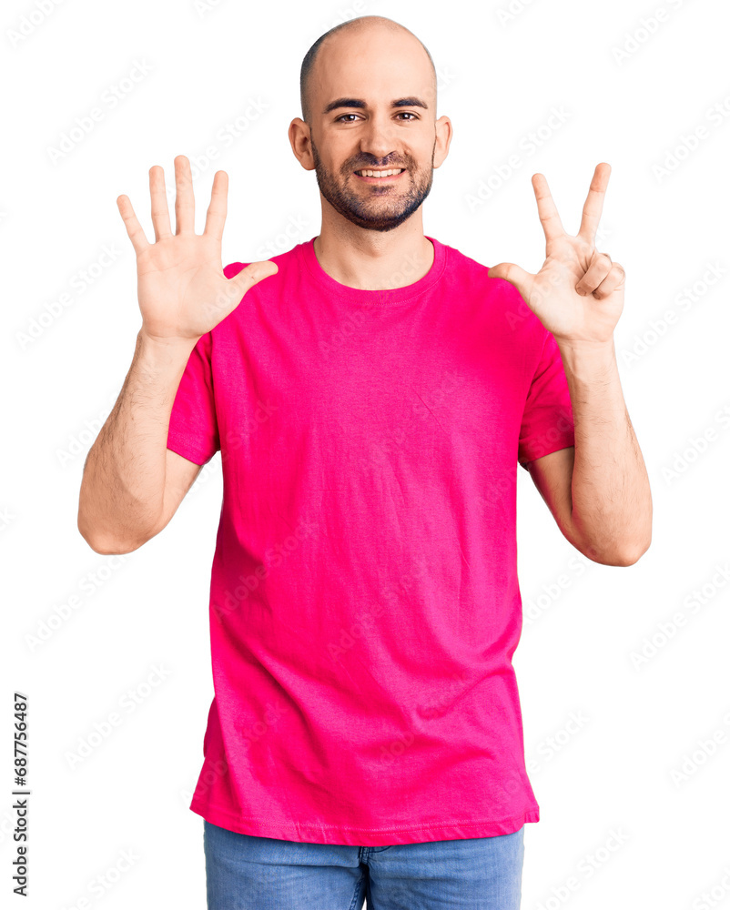 Young handsome man wearing casual t shirt showing and pointing up with fingers number eight while smiling confident and happy. Young handsome man wearing casual t shirt showing and pointing up with fingers number eight while smiling confident and happy.