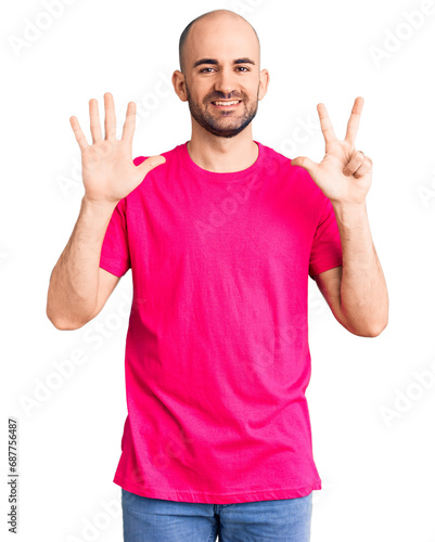 Young handsome man wearing casual t shirt showing and pointing up with fingers number eight while smiling confident and happy.
