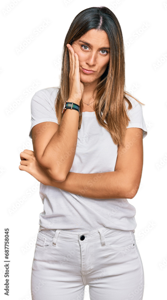 Young woman wearing casual white t shirt thinking looking tired and bored with depression problems with crossed arms. Young woman wearing casual white t shirt thinking looking tired and bored with depression problems with crossed arms.