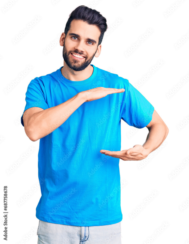 Young handsome man with beard wearing casual t-shirt gesturing with hands showing big and large size sign, measure symbol. smiling looking at the camera. measuring concept. Young handsome man with beard wearing casual t-shirt gesturing with hands showing big and large size sign, measure symbol. smiling looking at the camera. measuring concept.