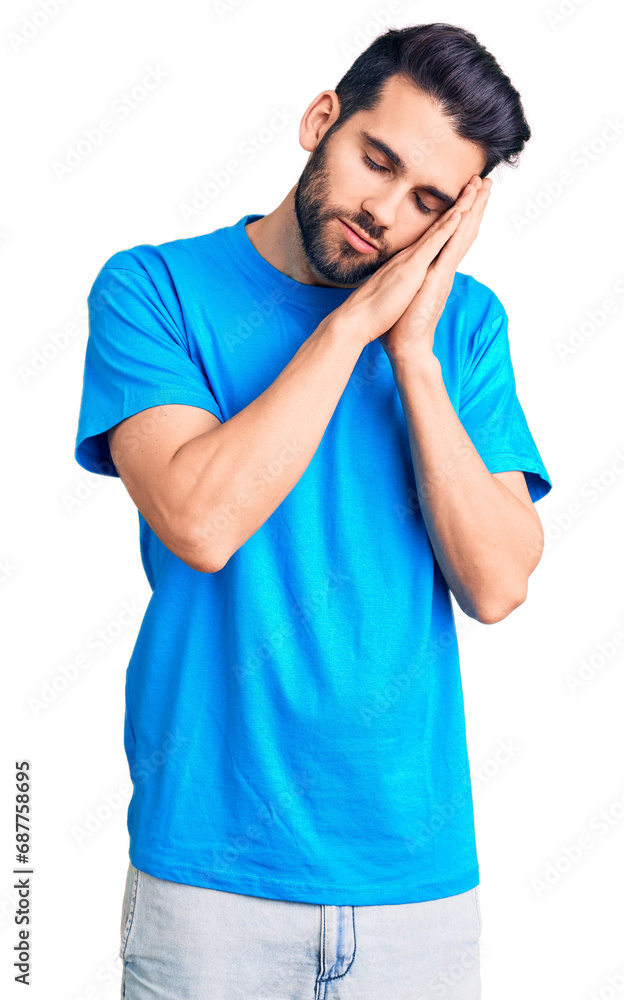 Young handsome man with beard wearing casual t-shirt sleeping tired dreaming and posing with hands together while smiling with closed eyes. Young handsome man with beard wearing casual t-shirt sleeping tired dreaming and posing with hands together while smiling with closed eyes.
