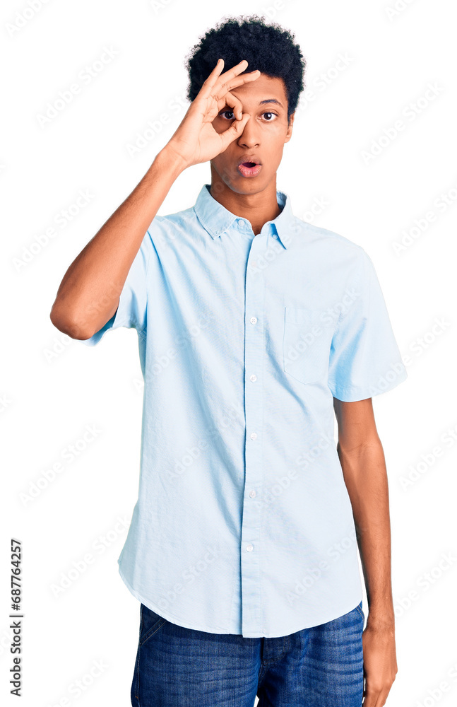 Young african american man wearing casual clothes doing ok gesture shocked with surprised face, eye looking through fingers. unbelieving expression. Young african american man wearing casual clothes doing ok gesture shocked with surprised face, eye looking through fingers. unbelieving expression.