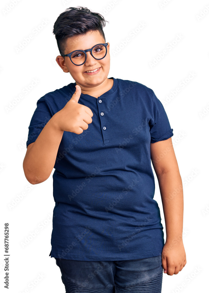 Little boy kid wearing casual clothes and glasses doing happy thumbs up gesture with hand. approving expression looking at the camera showing success. Little boy kid wearing casual clothes and glasses doing happy thumbs up gesture with hand. approving expression looking at the camera showing success.