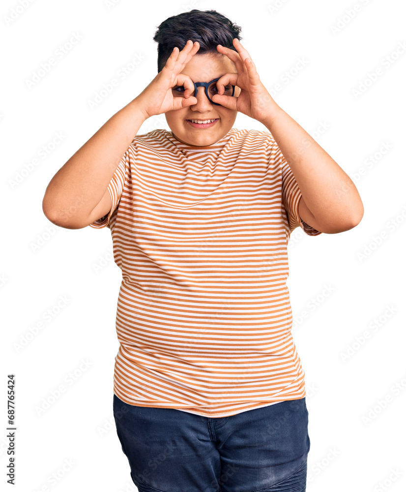 Little boy kid wearing casual clothes and glasses doing ok gesture like binoculars sticking tongue out, eyes looking through fingers. crazy expression. Little boy kid wearing casual clothes and glasses doing ok gesture like binoculars sticking tongue out, eyes looking through fingers. crazy expression.