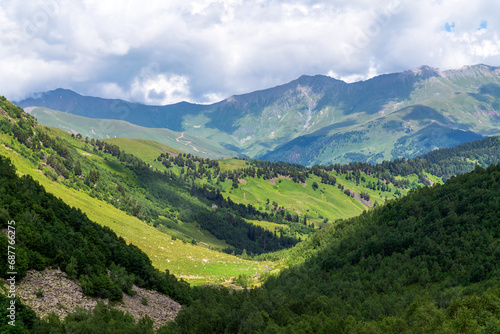 The valley of the Malaya Dukka River surrounded by the mountains of the North Caucasus and the tourist trail to the Dukka Lakes on a sunny summer day, Arkhyz, Karachay-Cherkessia, Russia © Ula Ulachka