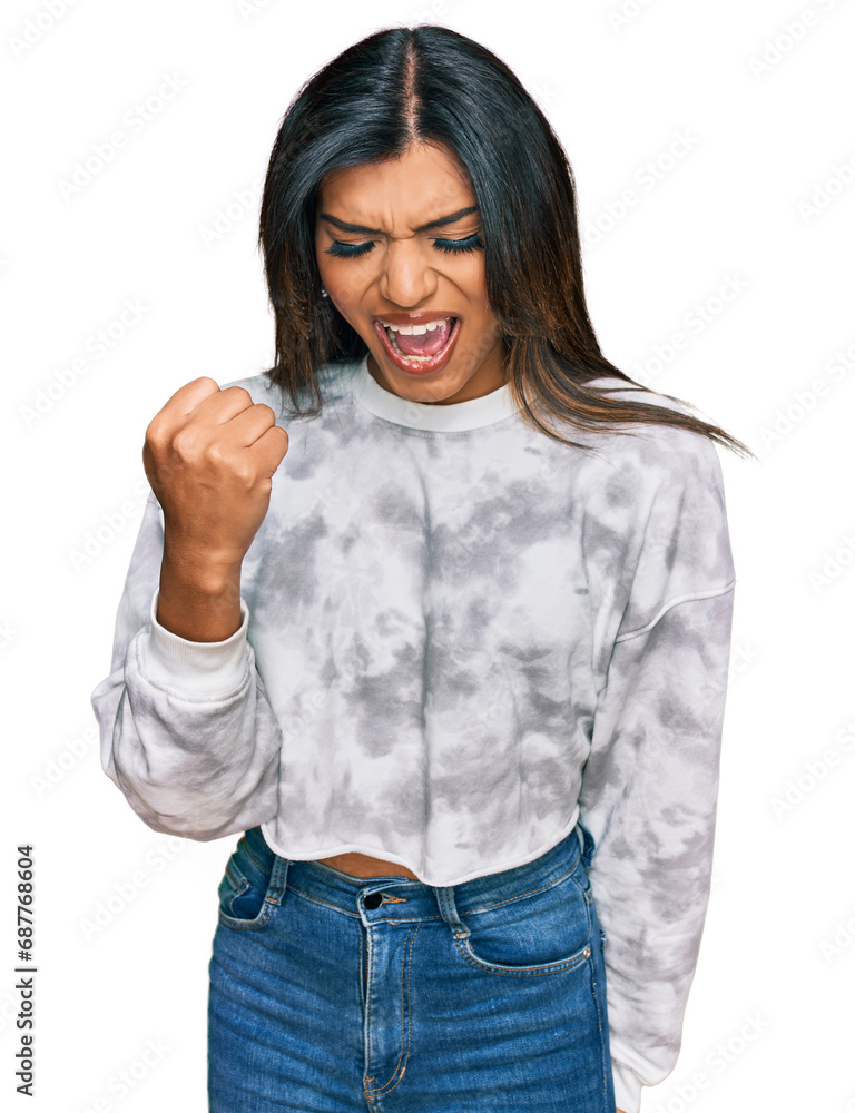 Young latin transsexual transgender woman wearing casual clothes angry and mad raising fist frustrated and furious while shouting with anger. rage and aggressive concept. Young latin transsexual transgender woman wearing casual clothes angry and mad raising fist frustrated and furious while shouting with anger. rage and aggressive concept.