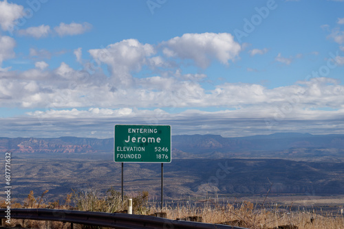 Entering Jerome sign with Elevation 5246 and Founded 1876. Beautiful landscape of the mountains behind the sign