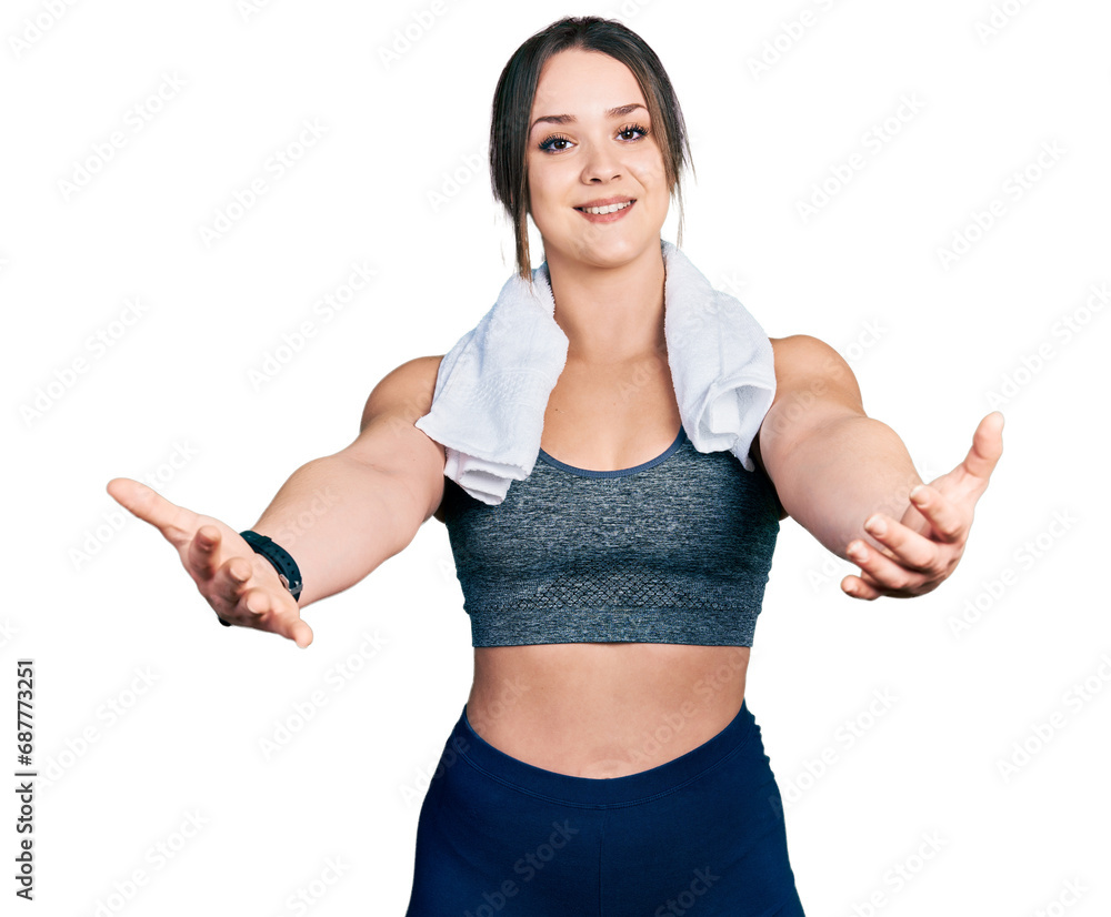 Young hispanic girl wearing sportswear and towel looking at the camera smiling with open arms for hug. cheerful expression embracing happiness. Young hispanic girl wearing sportswear and towel looking at the camera smiling with open arms for hug. cheerful expression embracing happiness.
