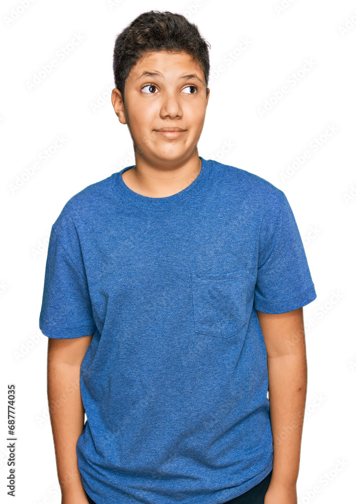Teenager hispanic boy wearing casual clothes smiling looking to the side and staring away thinking. Teenager hispanic boy wearing casual clothes smiling looking to the side and staring away thinking.