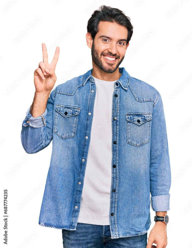 Young hispanic man wearing casual clothes showing and pointing up with fingers number two while smiling confident and happy. Young hispanic man wearing casual clothes showing and pointing up with fingers number two while smiling confident and happy.