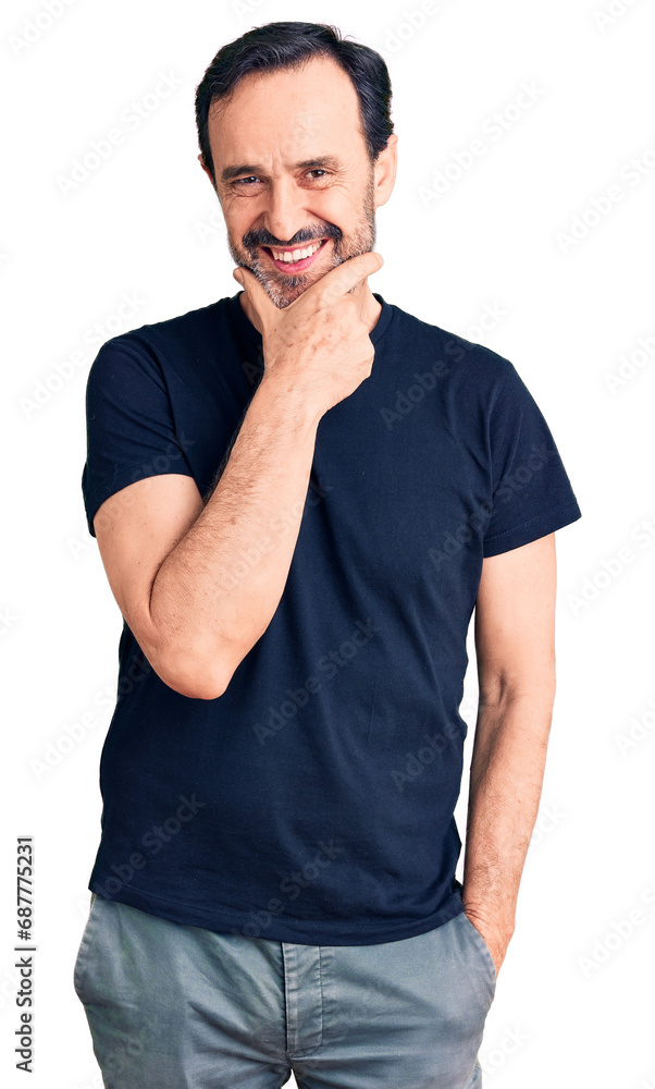 Middle age handsome man wearing casual t-shirt looking confident at the camera smiling with crossed arms and hand raised on chin. thinking positive. Middle age handsome man wearing casual t-shirt looking confident at the camera smiling with crossed arms and hand raised on chin. thinking positive.