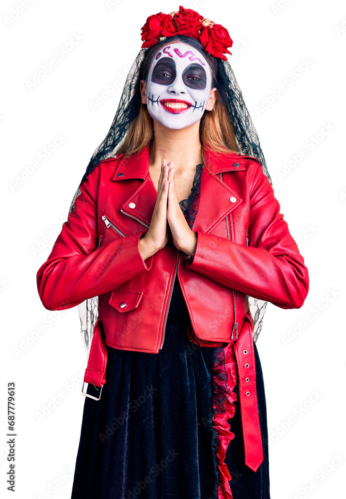 Woman wearing day of the dead costume over background praying with hands together asking for forgiveness smiling confident. Woman wearing day of the dead costume over background praying with hands together asking for forgiveness smiling confident.