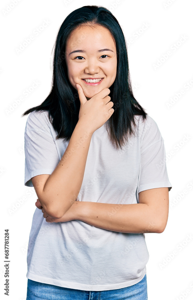 Young chinese woman wearing casual white t shirt looking confident at the camera smiling with crossed arms and hand raised on chin. thinking positive. Young chinese woman wearing casual white t shirt looking confident at the camera smiling with crossed arms and hand raised on chin. thinking positive.