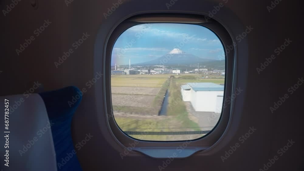 View of Mount Fuji through the window onboard a high speed train in Japan View of Mount Fuji through the window onboard a high speed train in Japan
