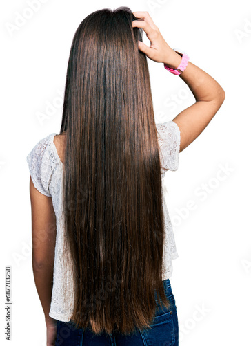 Young brunette girl with long hair wearing white shirt backwards thinking about doubt with hand on head