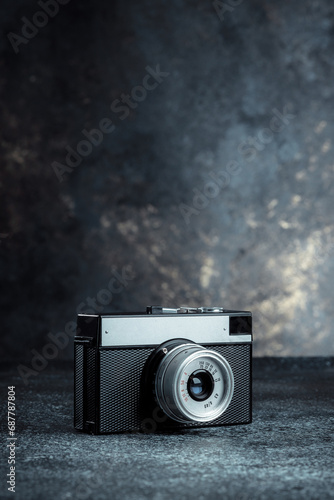Old mechanical film camera. Long range hipster camera. Minimalist monolithic design of the camera and optics. Hobby of analog retro shooting on 35mm film.
