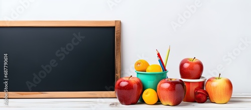 Blank chalk board and school lunch on white.