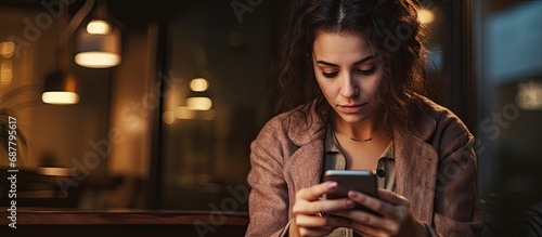 Anxious woman using smartphone to make online payment.