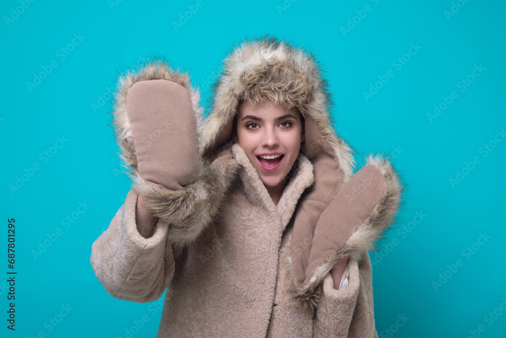 Funny excited Woman in winter warm hat and Winter gloves. Fun girl in woolen coat. Girl in winters cloth. Young woman in winter coat knitted sweater scarf and hat. Winter cold season. Funny excited Woman in winter warm hat and Winter gloves. Fun girl in woolen coat. Girl in winters cloth. Young woman in winter coat knitted sweater scarf and hat. Winter cold season.