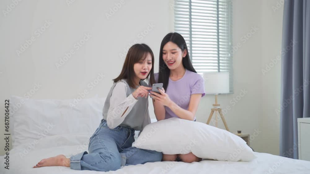 Asian woman happy and cheerful while using smartphones and working. Young businesswoman using apps on cell phones, reading news, fast connection Asian woman happy and cheerful while using smartphones and working. Young businesswoman using apps on cell phones, reading news, fast connection
