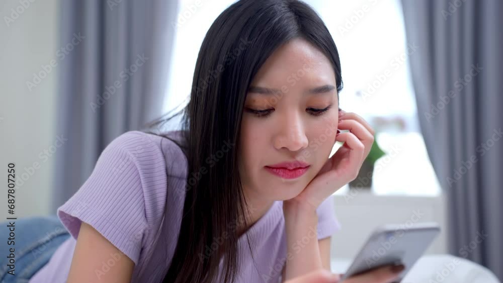 Bored young asian woman, Young busy stressed upset Asian business woman holding cellphone using mobile phone. Bored young asian woman, Young busy stressed upset Asian business woman holding cellphone using mobile phone.