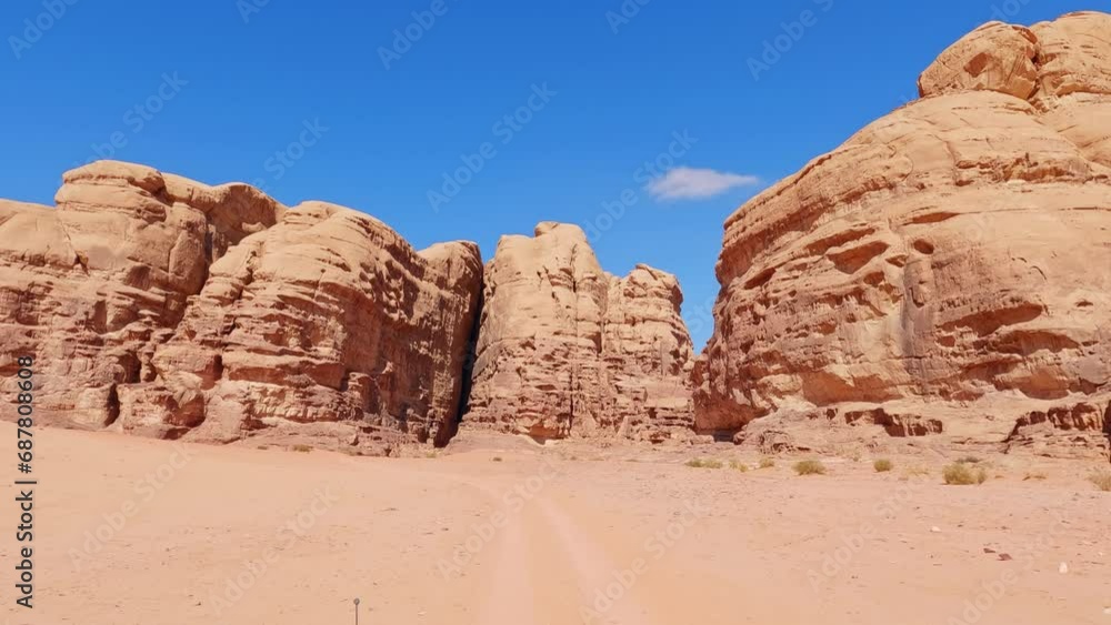 Driving on sand towards the rock formations of Wadi Rum desert. Driver POV Driving on sand towards the rock formations of Wadi Rum desert. Driver POV