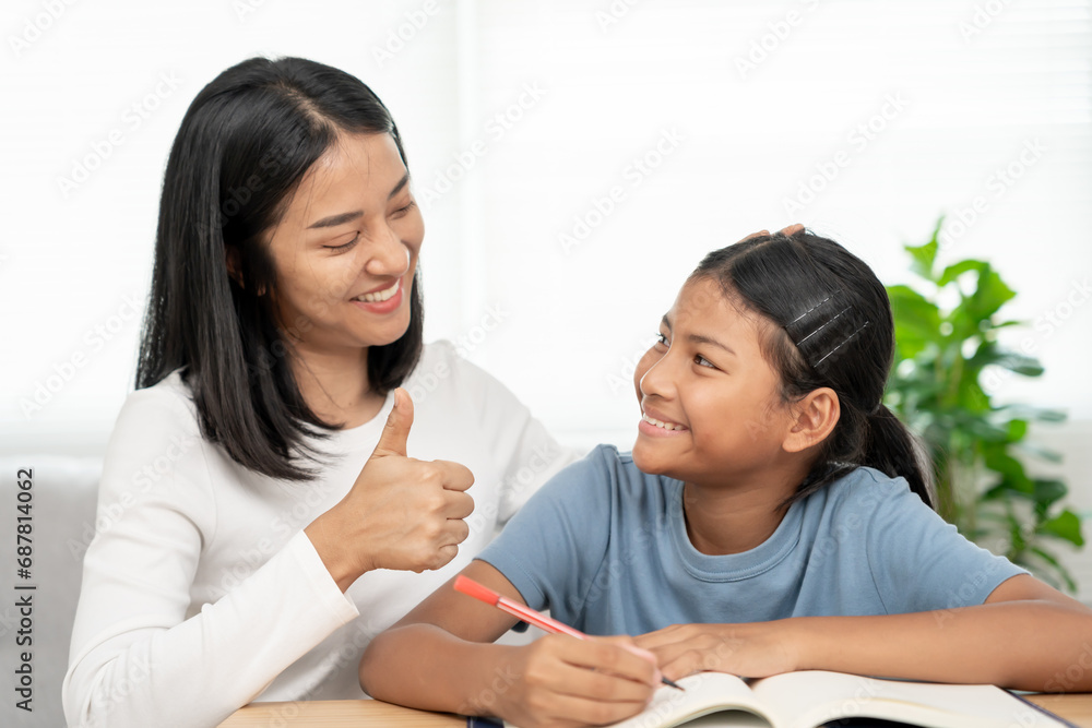 Mother teaching lesson for daughter. Asian young little girl learn at home. Do homework with kind mother help, encourage for exam.. Girl happy Homeschool. Mom advice education together. Mother teaching lesson for daughter. Asian young little girl learn at home. Do homework with kind mother help, encourage for exam.. Girl happy Homeschool. Mom advice education together.