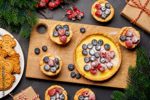 Fototapeta Naklejka Na Ścianę i Meble -  Festive delight: Christmas cupcakes adorned with berries