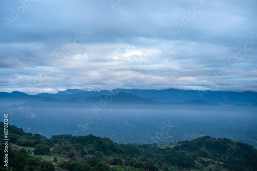 There are layers of white clouds floating over the valley villages. Ginger Garden Agritourism Area, Miaoli County, Taiwan. © twabian