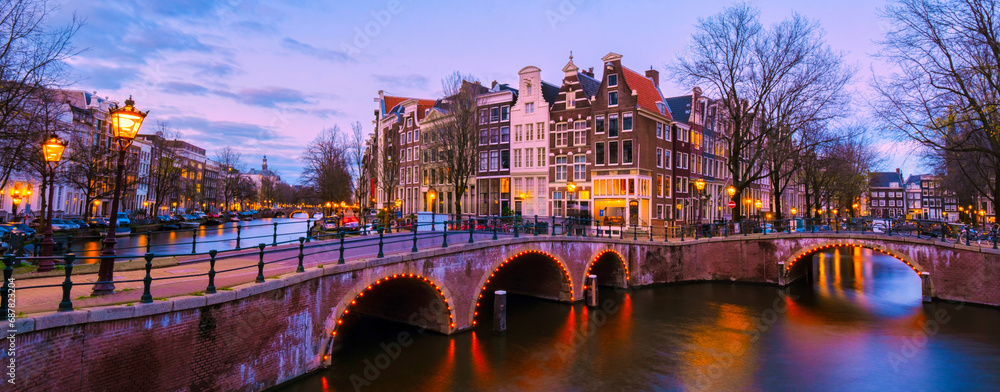 Amsterdam Netherlands canals with lights during evening in December during winter in the Netherlands